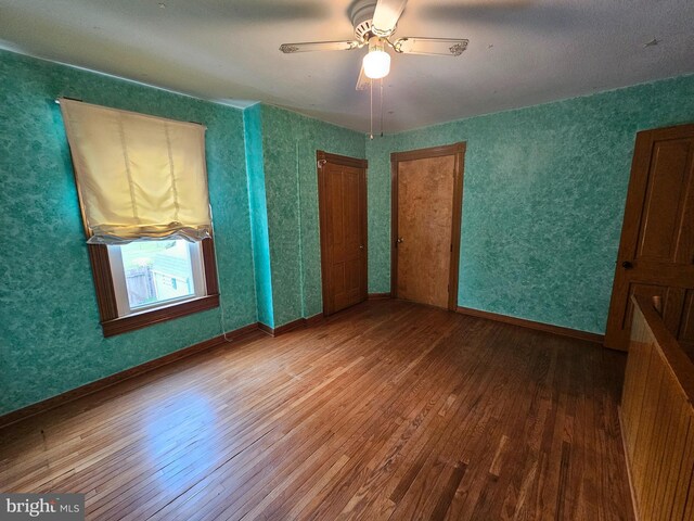 304 Pulaski St, Cumberland, MD 21502 - unfurnished bedroom with wood-type flooring and ceiling fan