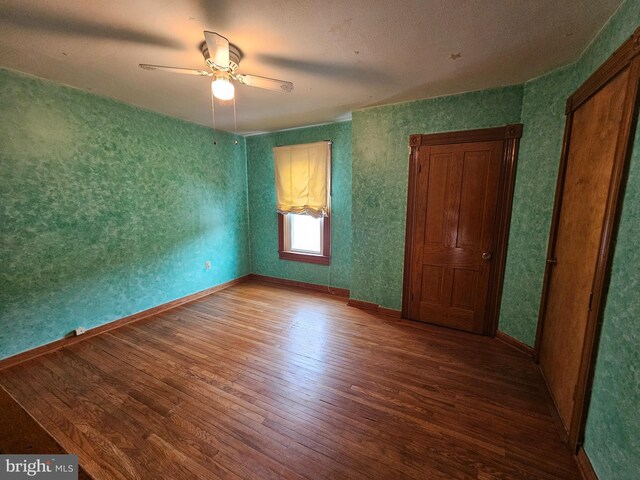 304 Pulaski St, Cumberland, MD 21502 - unfurnished bedroom featuring wood finished floors, baseboards, and a ceiling fan