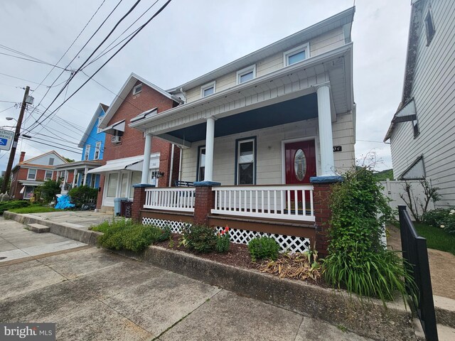 304 Pulaski St, Cumberland, MD 21502 - townhome / multi-family property featuring covered porch