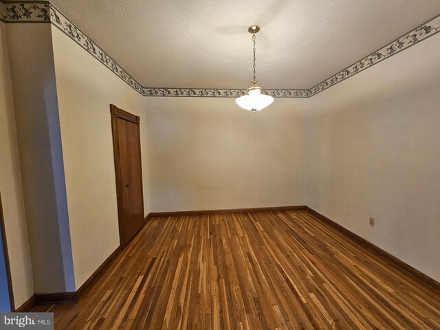 304 Pulaski St, Cumberland, MD 21502 - empty room featuring dark wood-style flooring and baseboards