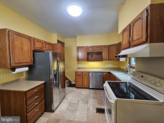 304 Pulaski St, Cumberland, MD 21502 - kitchen with appliances with stainless steel finishes, under cabinet range hood, a sink, and light countertops
