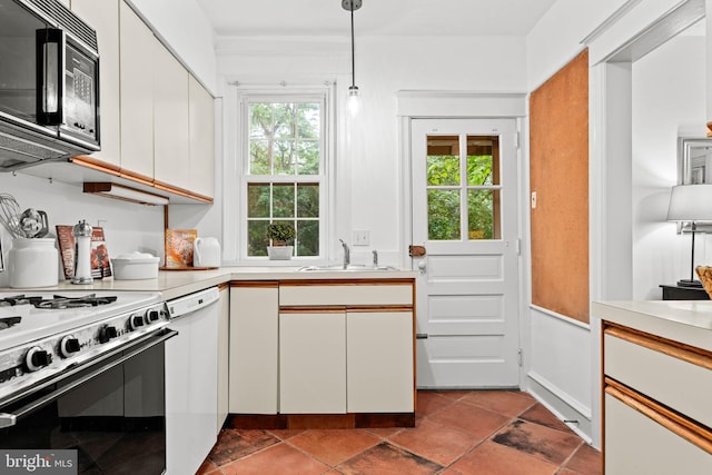 kitchen with black microwave, electric range, a sink, dishwasher, and light countertops