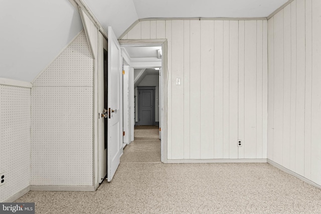 hallway featuring vaulted ceiling and carpet floors