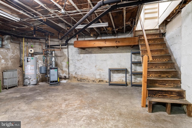 unfinished below grade area with gas water heater, radiator, and a heating unit
