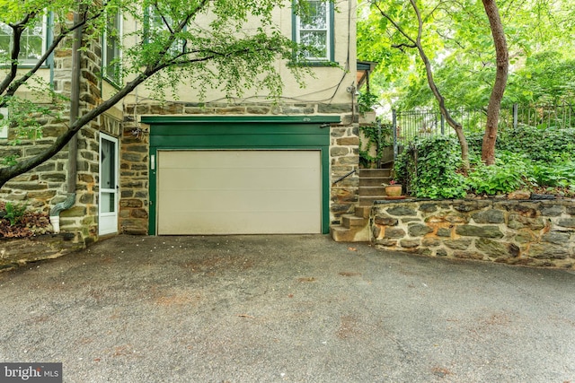 garage with asphalt driveway