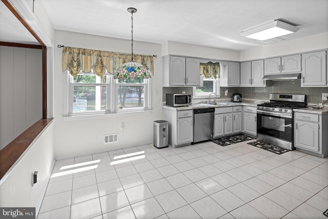 19 Strassberg Ct, Hamilton, NJ 08690 - kitchen featuring stainless steel appliances, under cabinet range hood, gray cabinets, light countertops, and decorative backsplash
