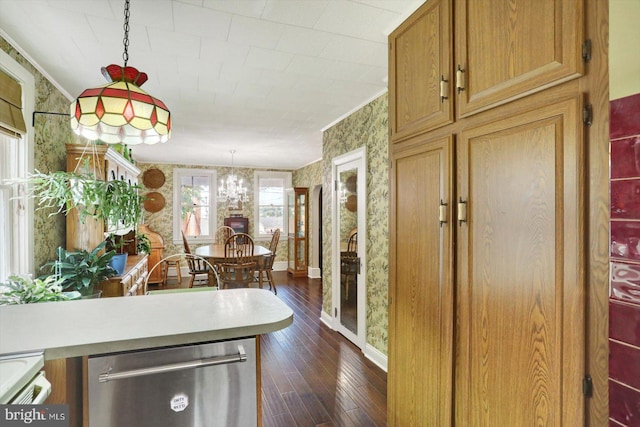 foyer with wallpapered walls, baseboards, dark wood finished floors, ornamental molding, and a chandelier