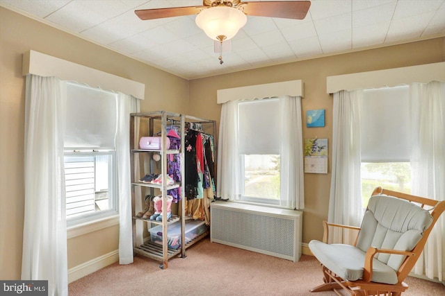 carpeted bedroom featuring radiator and ceiling fan