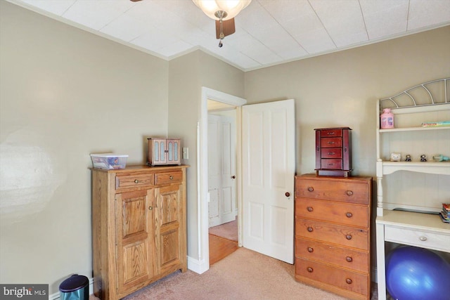 bedroom with light colored carpet and a ceiling fan