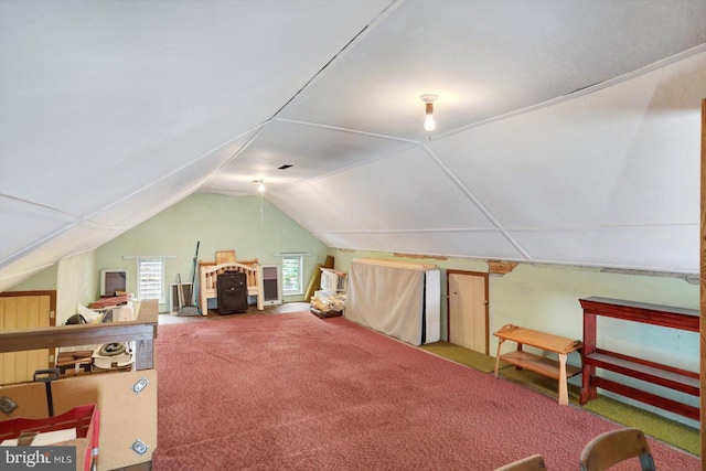bonus room with carpet and vaulted ceiling