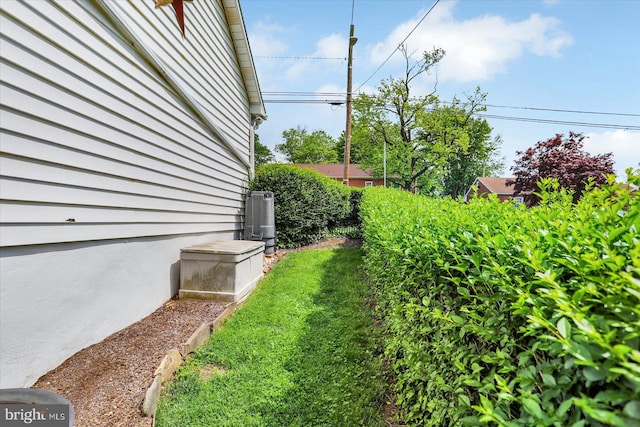 view of yard featuring central air condition unit