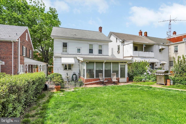back of property with a sunroom