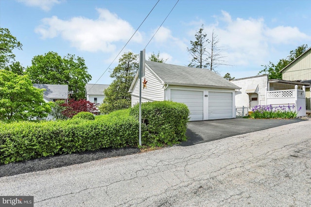 view of front of property with an outdoor structure and a garage