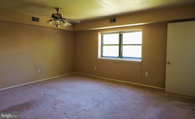 spare room with a ceiling fan, carpet flooring, and baseboards