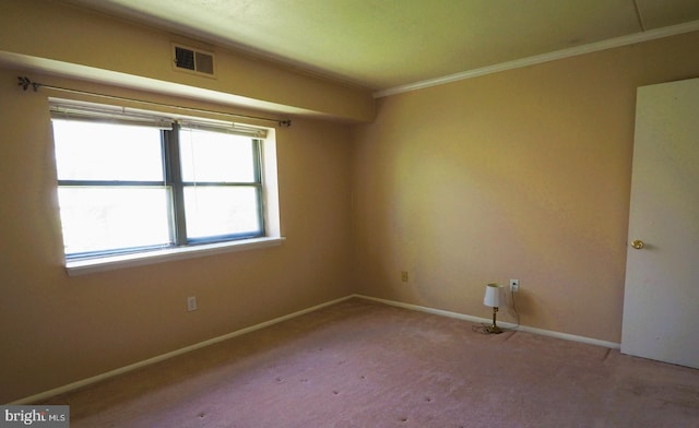 empty room featuring baseboards, ornamental molding, and carpet flooring