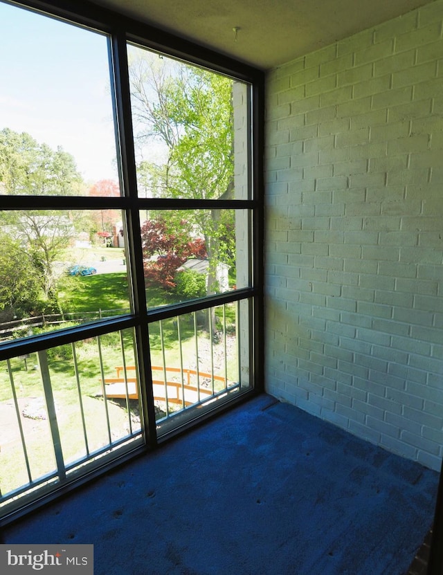 unfurnished sunroom featuring healthy amount of natural light