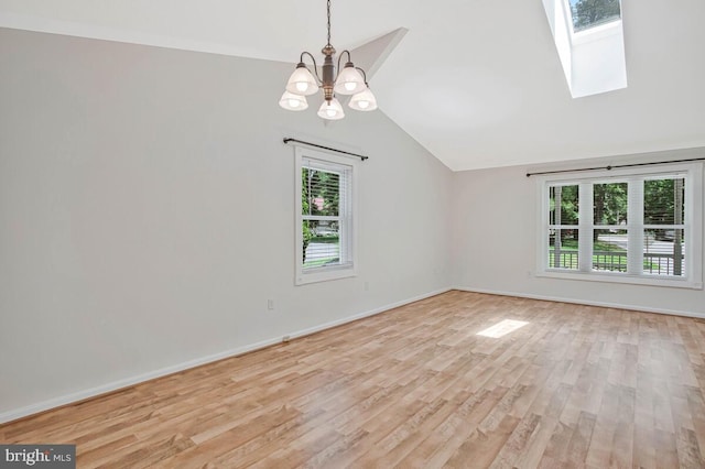 11545 Tomahawk Trl W, Lusby, MD 20657 - unfurnished room featuring vaulted ceiling, a chandelier, light wood-type flooring, and a skylight
