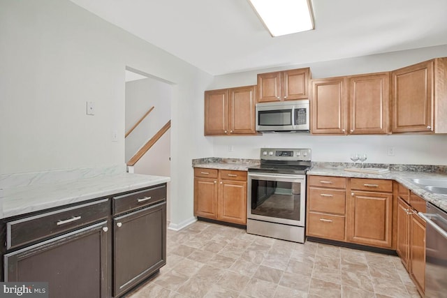 11545 Tomahawk Trl W, Lusby, MD 20657 - kitchen with appliances with stainless steel finishes and light stone countertops