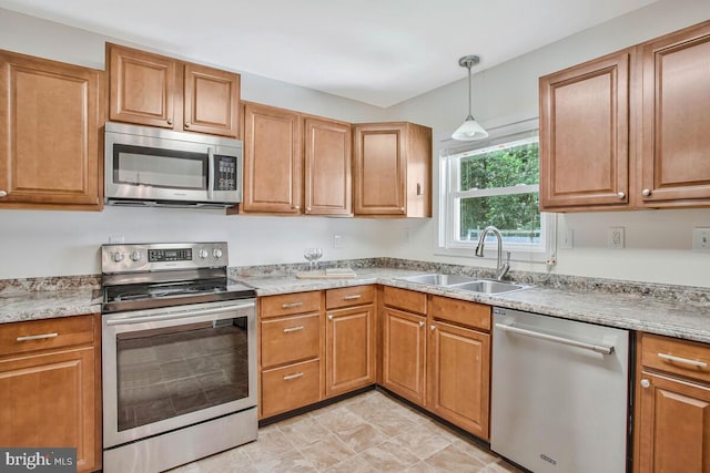 11545 Tomahawk Trl W, Lusby, MD 20657 - kitchen featuring stainless steel appliances, brown cabinetry, and light countertops