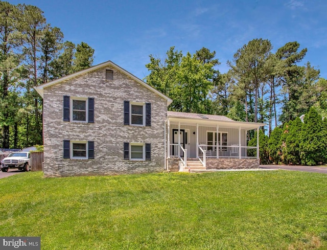 11545 Tomahawk Trl W, Lusby, MD 20657 - split level home with covered porch, a front lawn, brick siding, and board and batten siding