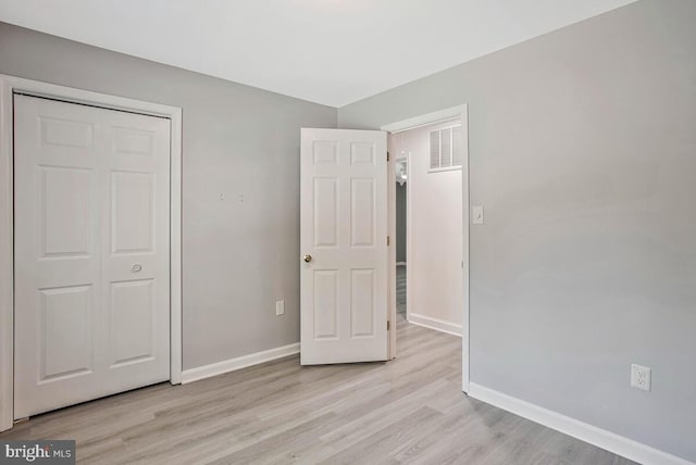 11545 Tomahawk Trl W, Lusby, MD 20657 - unfurnished bedroom featuring light wood-style floors and a closet