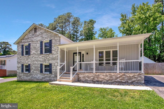 11545 Tomahawk Trl W, Lusby, MD 20657 - split level home featuring covered porch, brick siding, and board and batten siding