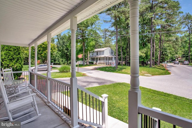 11545 Tomahawk Trl W, Lusby, MD 20657 - covered porch featuring a yard and view of wooded area