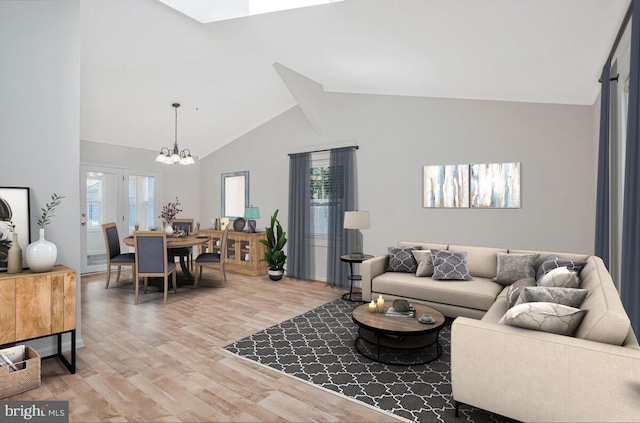 11545 Tomahawk Trl W, Lusby, MD 20657 - living area with plenty of natural light, light wood finished floors, a chandelier, and high vaulted ceiling