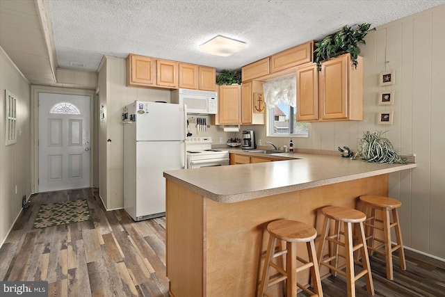 128 Captains Quarters Rd Unit 201, Ocean City, MD 21842 - kitchen with white appliances, light brown cabinets, wood finished floors, and a textured ceiling