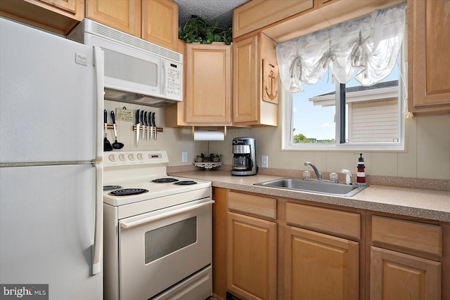 128 Captains Quarters Rd Unit 201, Ocean City, MD 21842 - kitchen with white appliances, a sink, light brown cabinets, and light countertops