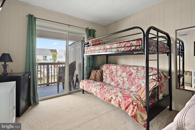 128 Captains Quarters Rd Unit 201, Ocean City, MD 21842 - carpeted bedroom featuring access to exterior and a textured ceiling