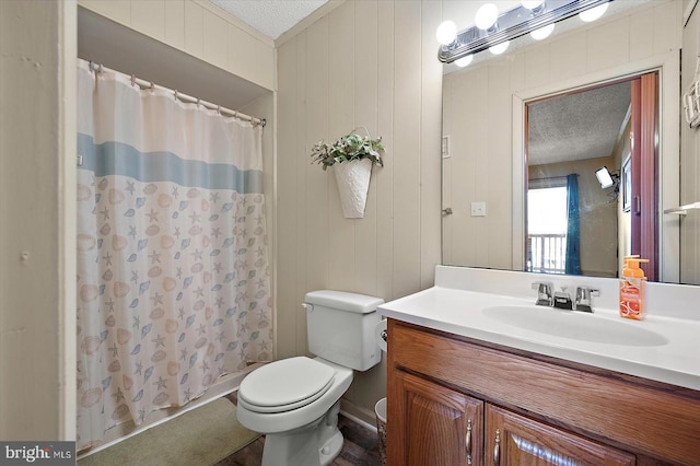 128 Captains Quarters Rd Unit 201, Ocean City, MD 21842 - bathroom featuring toilet, a textured ceiling, curtained shower, and vanity