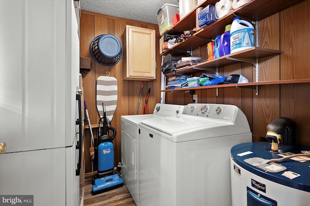 128 Captains Quarters Rd Unit 201, Ocean City, MD 21842 - laundry room featuring washing machine and clothes dryer, water heater, wood finished floors, wooden walls, and cabinet space