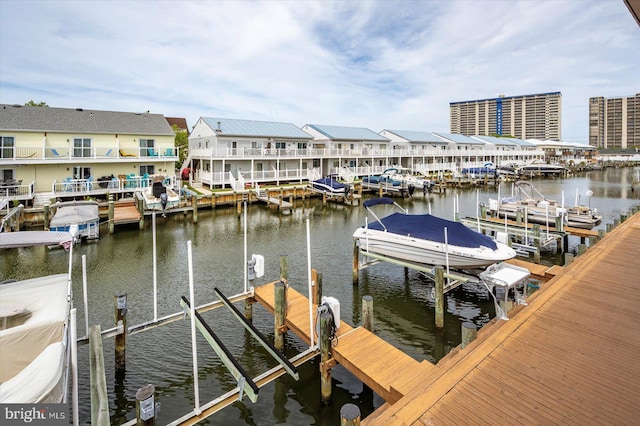 128 Captains Quarters Rd Unit 201, Ocean City, MD 21842 - dock featuring boat lift, a water view, and a residential view