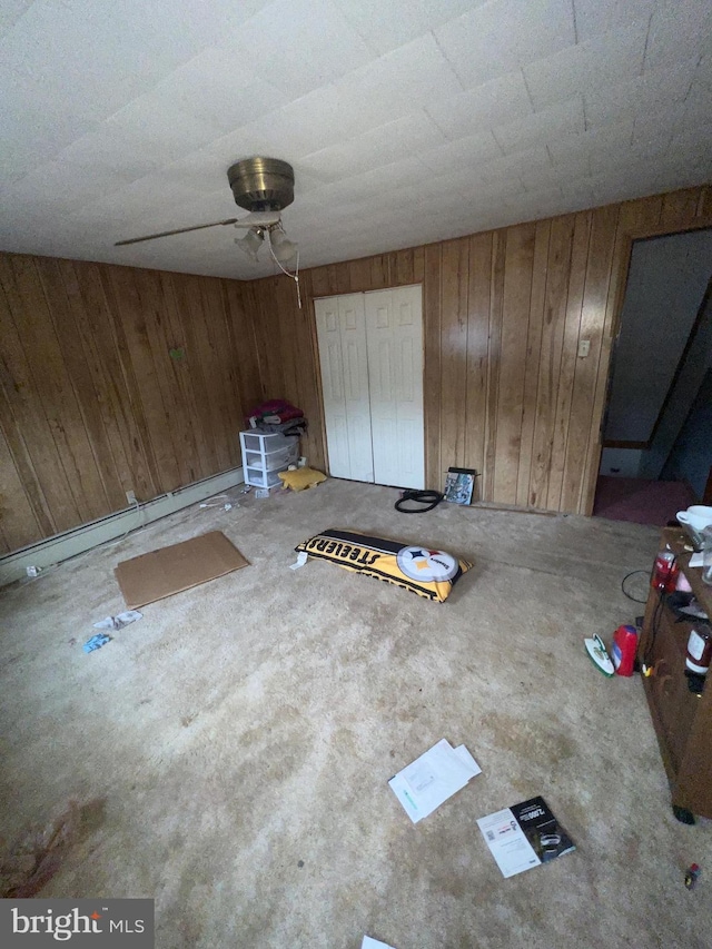 411 S Vine St, Shamokin, PA 17872 - unfurnished bedroom featuring wooden walls, carpet, and ceiling fan