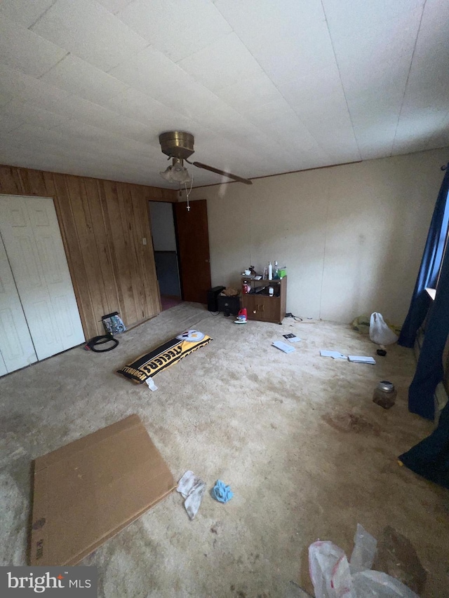 411 S Vine St, Shamokin, PA 17872 - unfurnished living room featuring ceiling fan and wooden walls