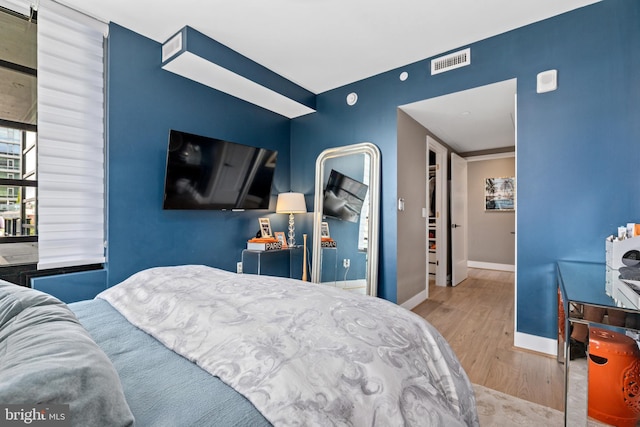 1300 4th St SE Unit 404, Washington, DC 20003 - bedroom featuring wood finished floors and baseboards