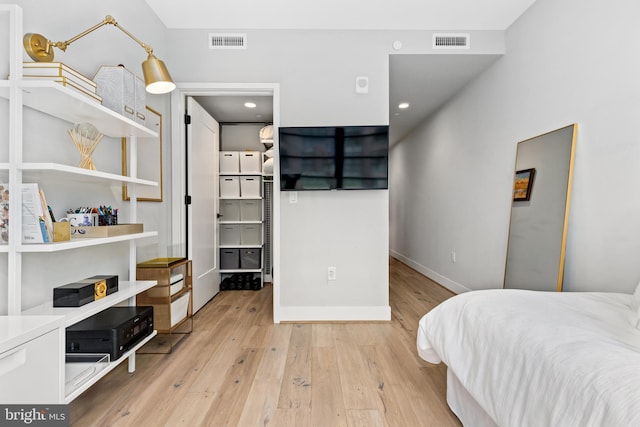 1300 4th St SE Unit 404, Washington, DC 20003 - bedroom with light wood-style flooring and baseboards