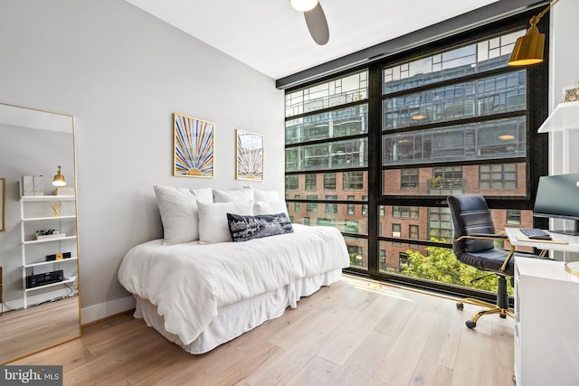 1300 4th St SE Unit 404, Washington, DC 20003 - bedroom featuring expansive windows, a desk, and wood finished floors