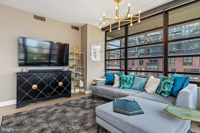 1300 4th St SE Unit 404, Washington, DC 20003 - living area featuring healthy amount of natural light, a chandelier, baseboards, and wood finished floors