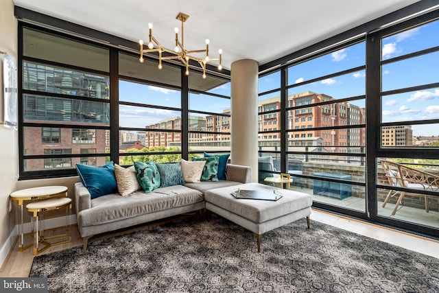 1300 4th St SE Unit 404, Washington, DC 20003 - sunroom / solarium with a chandelier, wood finished floors, a city view, and baseboards