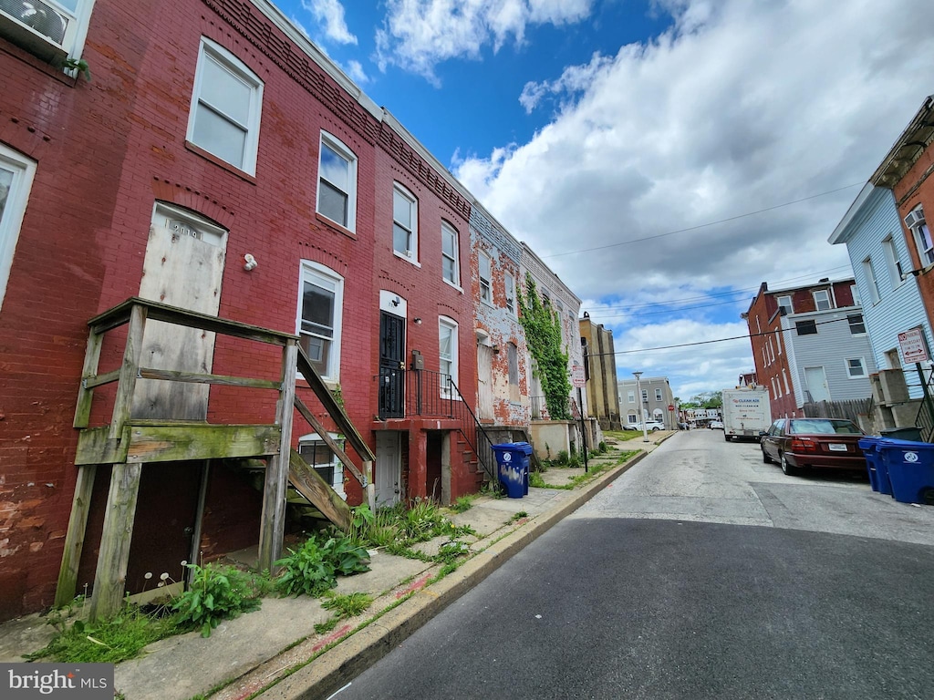 view of road with stairway, a residential view, and curbs