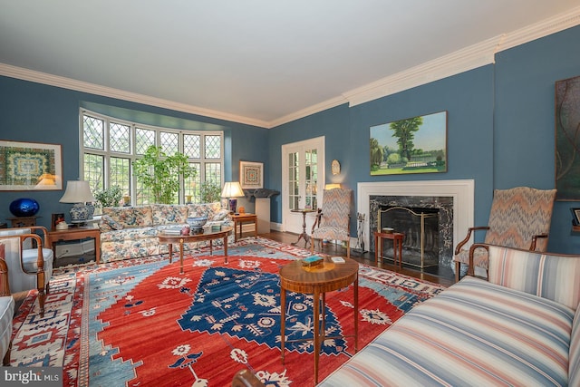 living area featuring ornamental molding, a high end fireplace, and baseboards