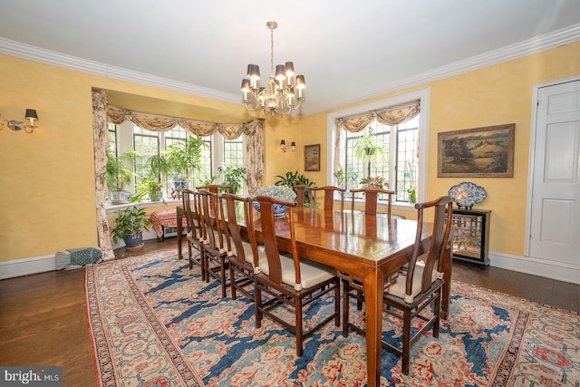 dining area with baseboards, plenty of natural light, crown molding, a chandelier, and hardwood / wood-style flooring
