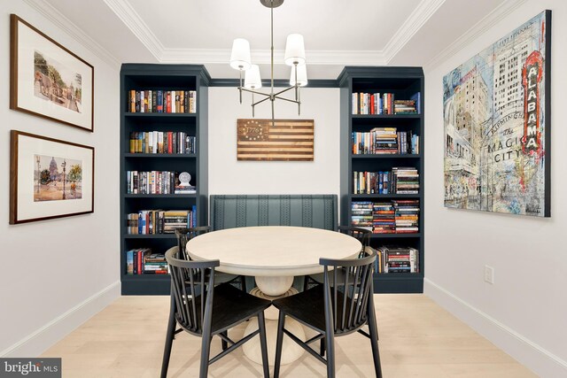 2122 N St NW Unit 1, Washington, DC 20037 - dining space featuring a chandelier, built in features, light wood finished floors, ornamental molding, and baseboards