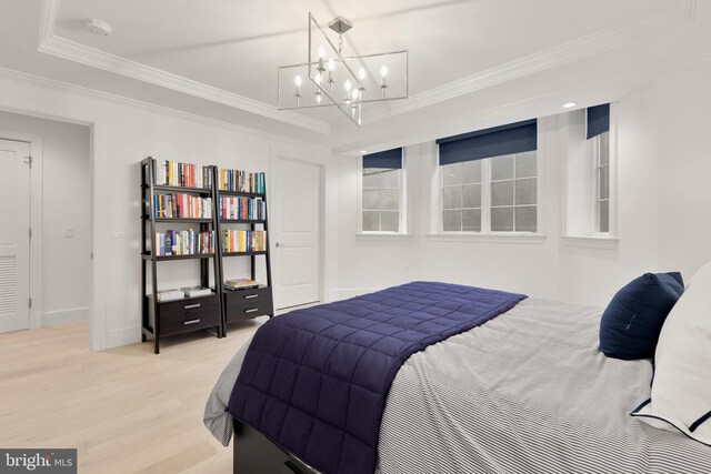 2122 N St NW Unit 1, Washington, DC 20037 - bedroom featuring light wood-type flooring, crown molding, a chandelier, and baseboards