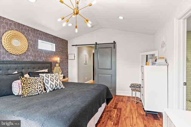 3503 Norris Pl, Alexandria, VA 22305 - bedroom with an accent wall, a barn door, lofted ceiling, wood finished floors, and baseboards