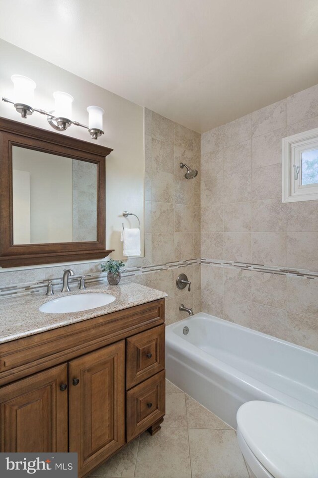 full bathroom featuring bathtub / shower combination, tile patterned floors, vanity, and toilet