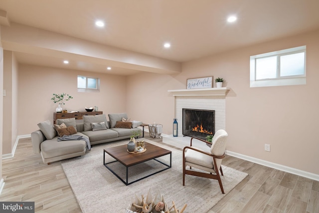 living room with recessed lighting, light wood-style flooring, a fireplace, healthy amount of natural light, and baseboards