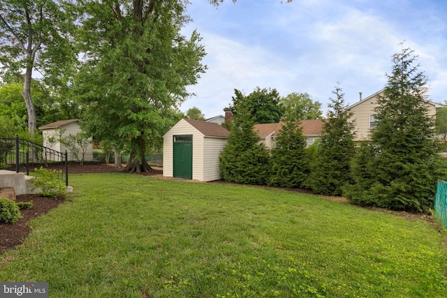 view of yard with a storage shed and an outbuilding